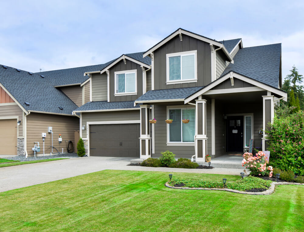 Modern Residential Front Exterior With a Grass Driveway