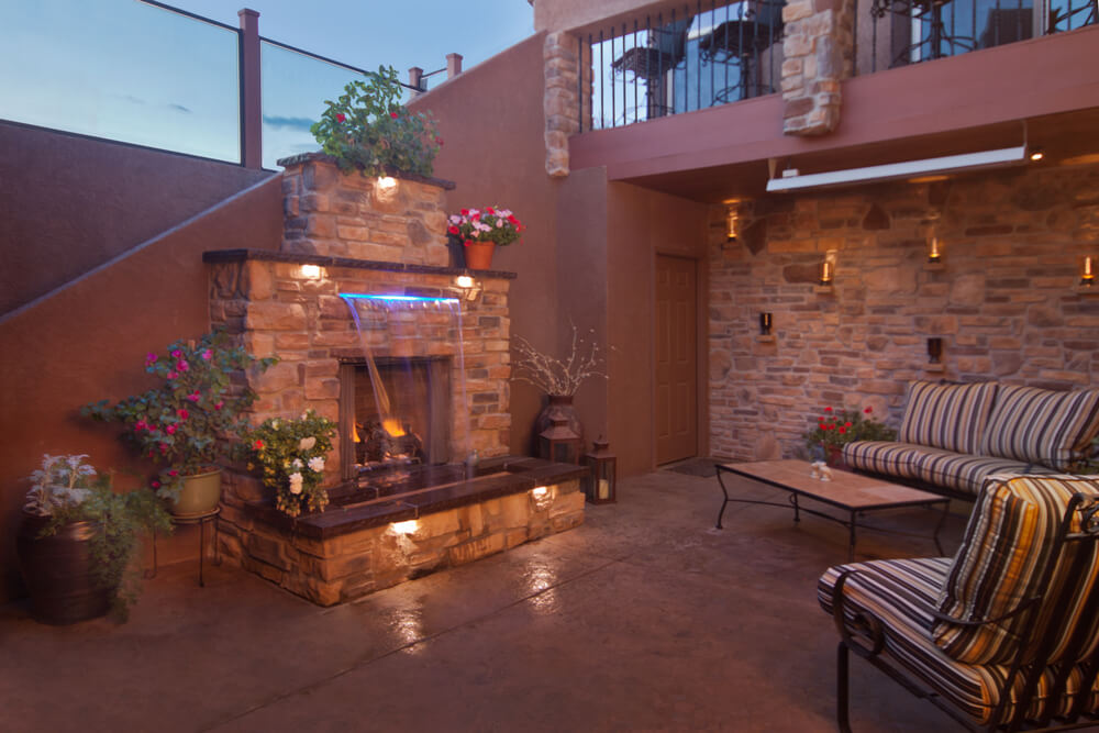 Outdoor Living Space With Awesome Fire Place With a Water Feature in Front