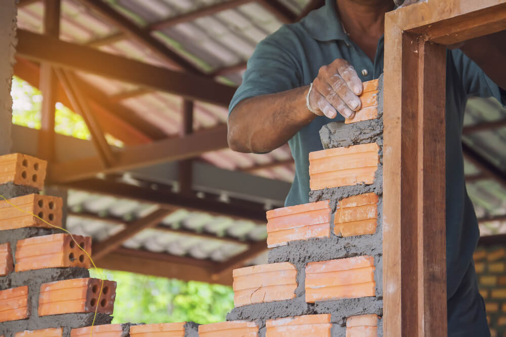 Man Building a Brick House