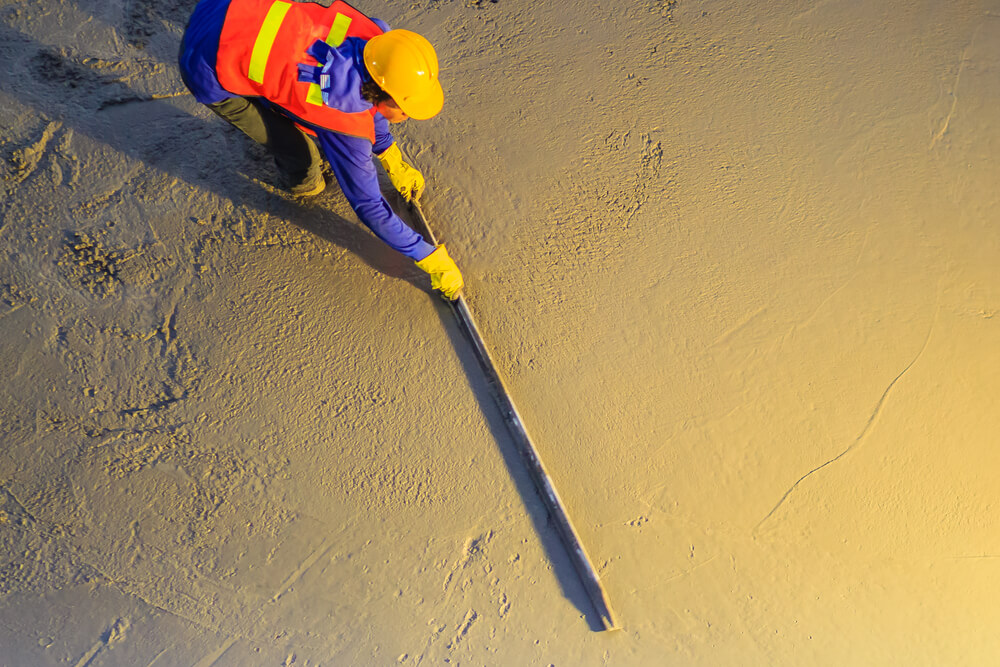 Worker Leveling Concrete With Trowels