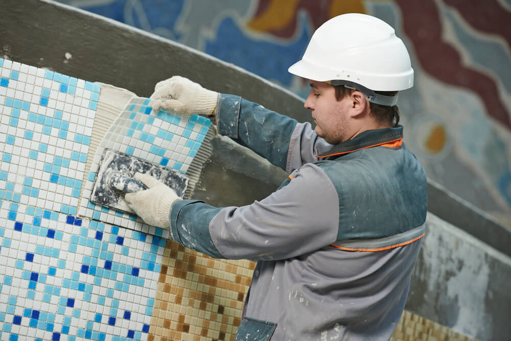 Industrial Tiler Builder Worker Installing Floor Tile at Repair Renovation Work