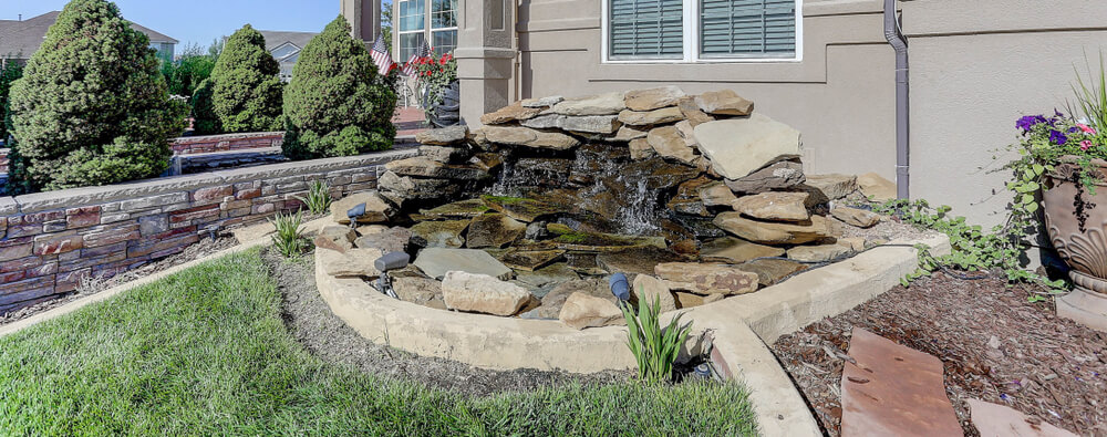 Water Feature and Stone Wall in Suburban Back Yard
