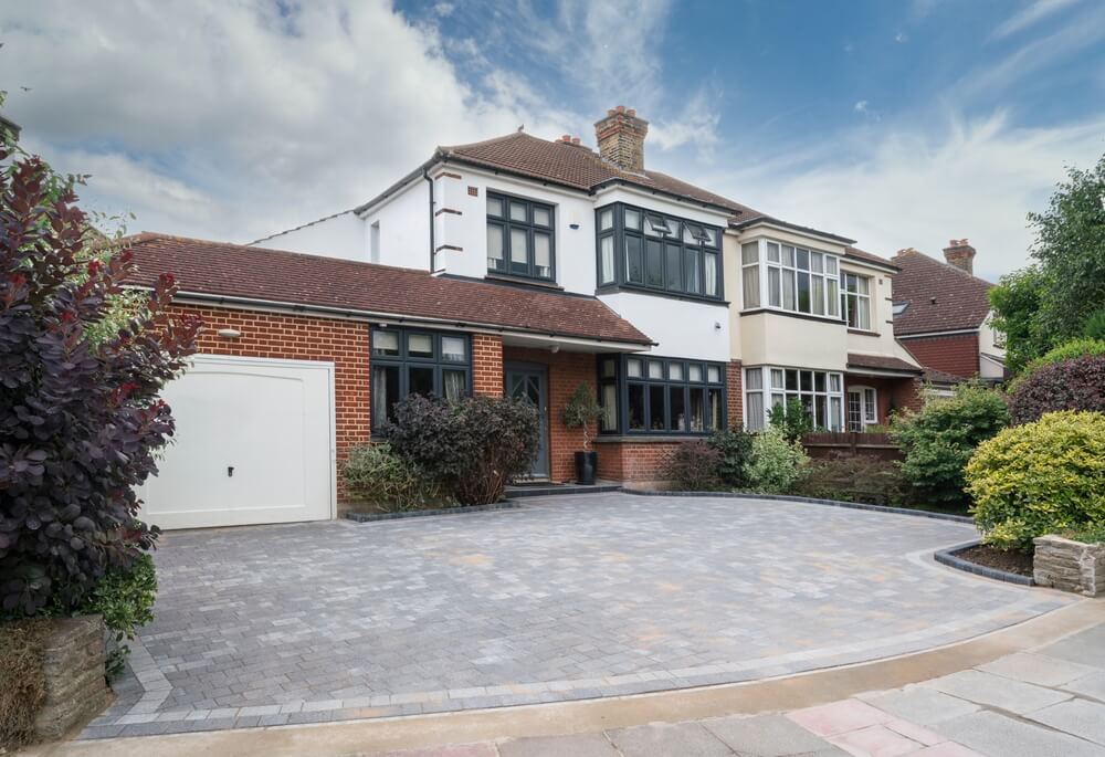 Typical British Semi-detached House In South East England Uk With Grey Anthracite Windows And Block Paving Driveway
